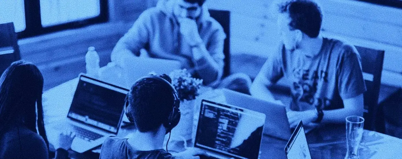 A team collaborating around laptops in a clean, minimalist office setting, focusing on data-driven strategy. The brand colors #C4C9A4 and #F8F9ED are prominent.